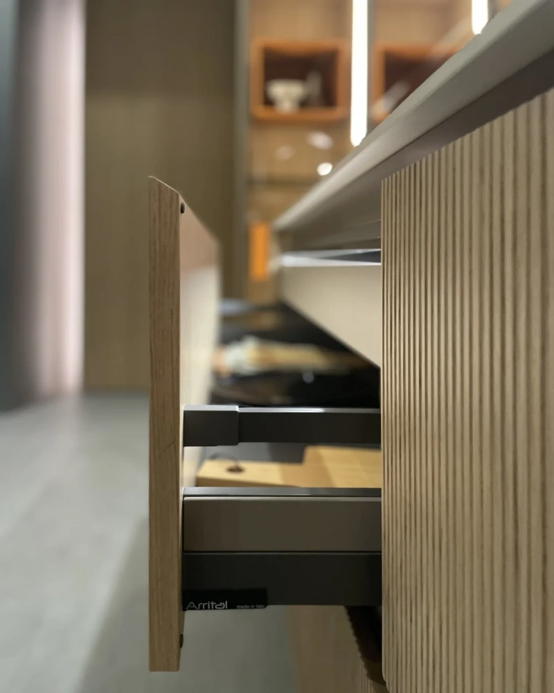 Arrital kitchen island with a light worktop and warm timber cabinetry.