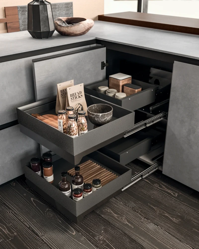 Open pull-out storage drawers fitted into the corner of an Arrital kitchen.