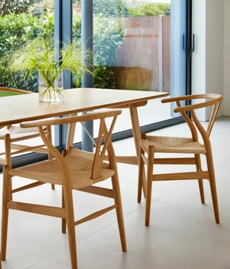 Carl Hansen & Son timber dining table with woven-seat wooden chairs