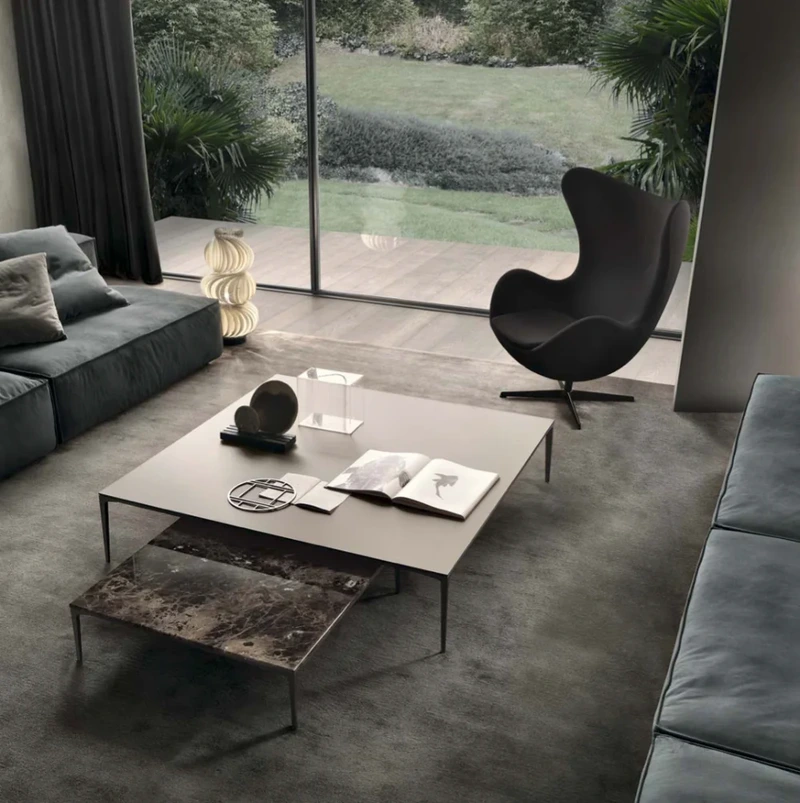 Rimadesio living room with a low coffee table, modular shelving and bronze-framed glazed panels