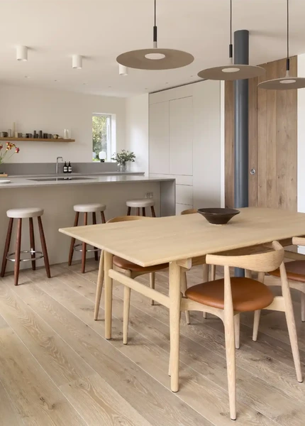 Carl Hansen & Son dining furniture beside a contemporary kitchen