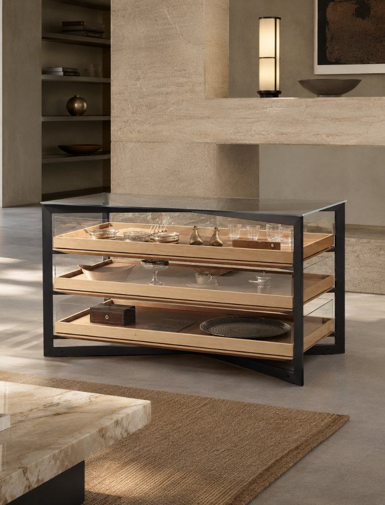 Low bulthaup b Solitaire sideboard display unit with a black frame, glass top and stainless-steel shelves holding tableware.