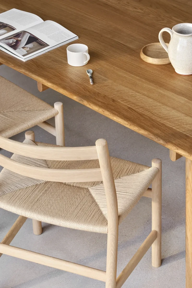 Carl Hansen & Søn dining chair and timber table showing the chair's curved wooden frame