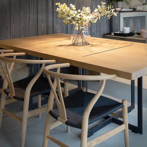 Carl Hansen & Søn CH24 Wishbone chairs in light timber arranged around a dining table in the Hobson’s Choice Bath studio.