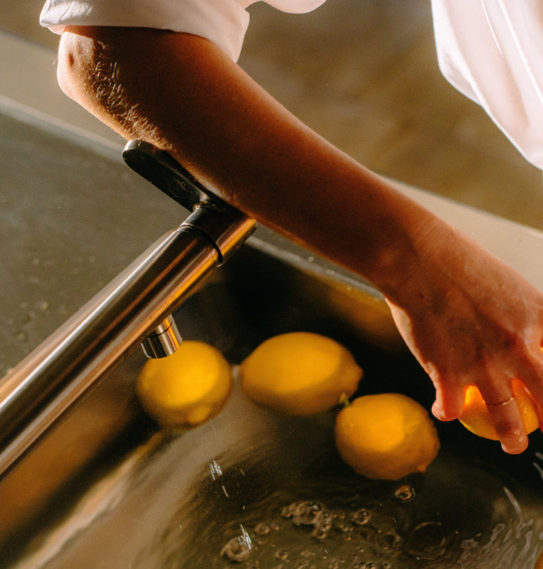 bulthaup mixer tap being operated with an arm while cooking