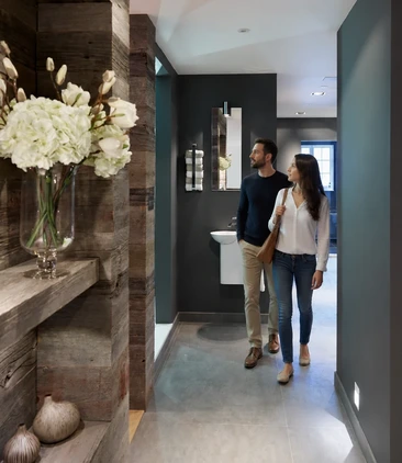 A couple walk through Hobson's Choice design studio in Swindon exploring the Bathroom room sets