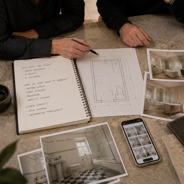 Bathroom designer reviewing material samples during a client consultation