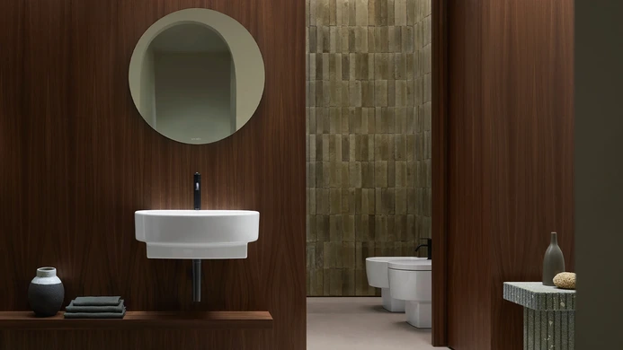 View though a bathroom showing the wall mounted sink and sanitaryware in the next space