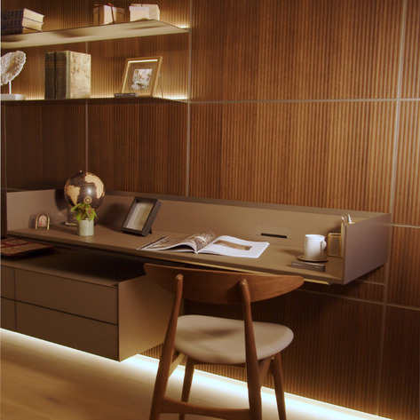 Wall-mounted Rimadesio Self sideboard in a pale finish beneath two artworks, with open shelf and drawer storage.