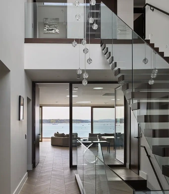 Contemporary waterfront interior with presentation kitchen opening onto the terrace